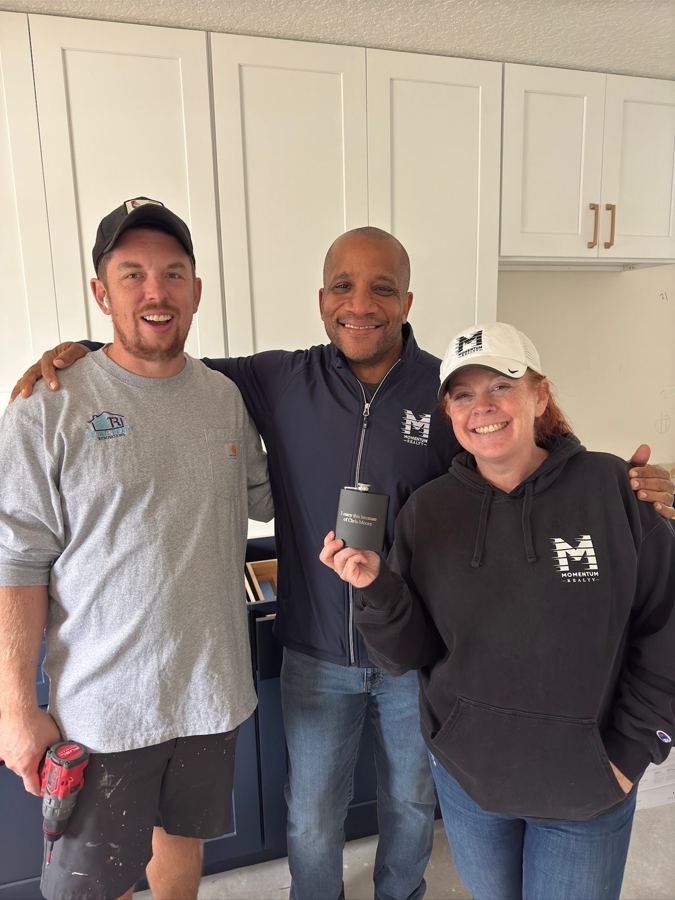 Chris with the crew in a renovated kitchen