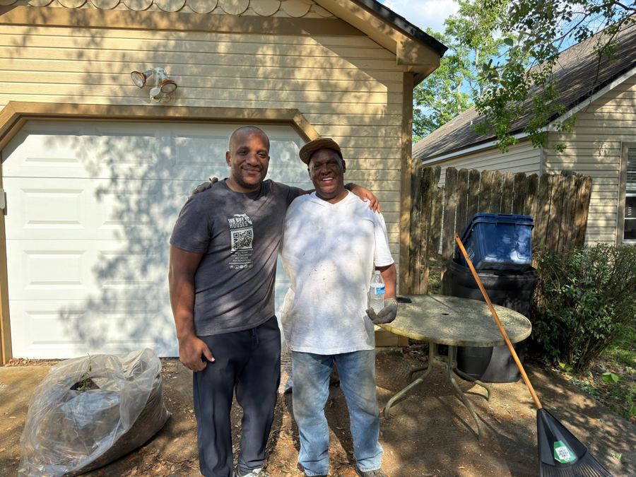 Chris with a seller in front of a garage