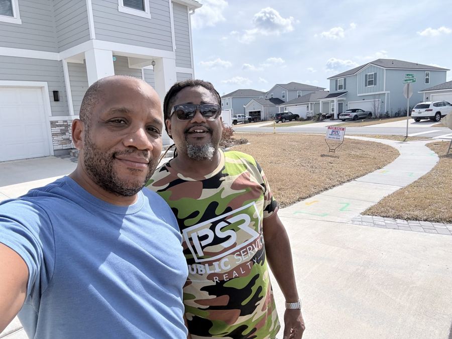 Chris with a fellow agent in a new subdivision